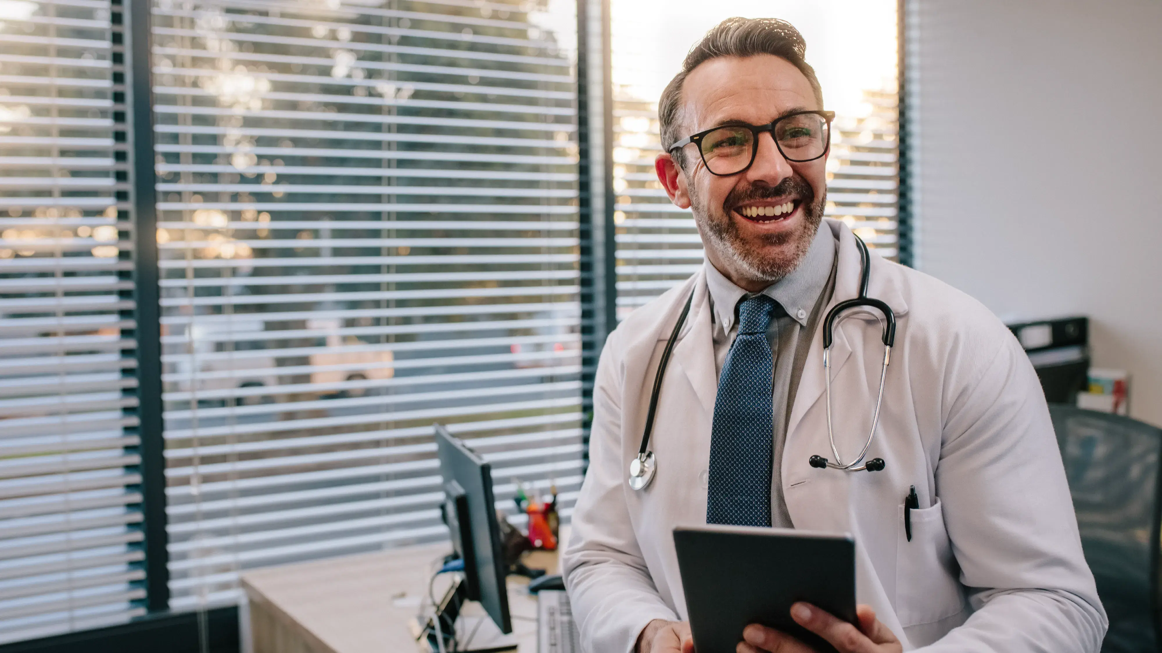 Doctor Smiling with a tablet in hand